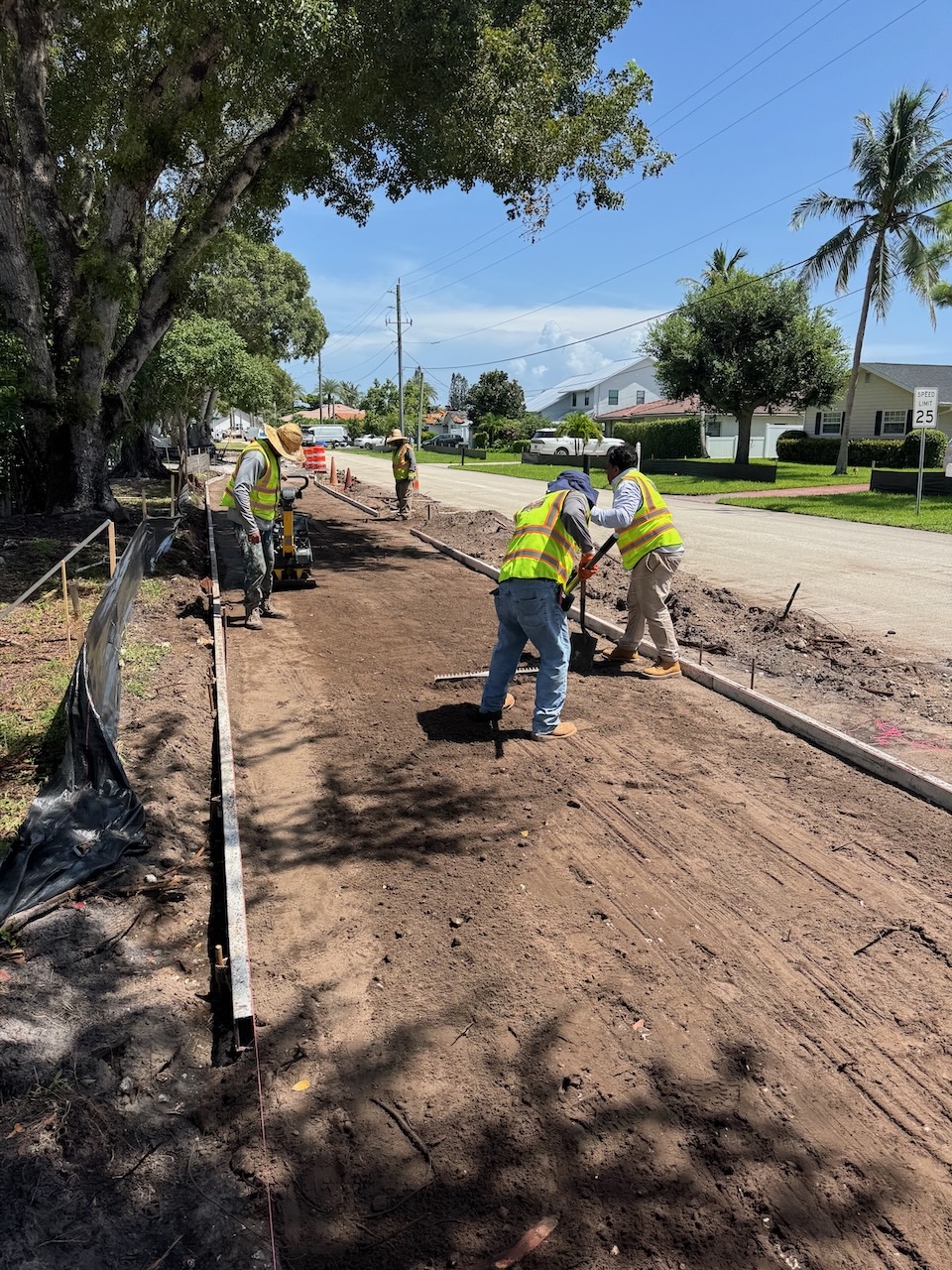 Crew preparing a sidewalk construction area
